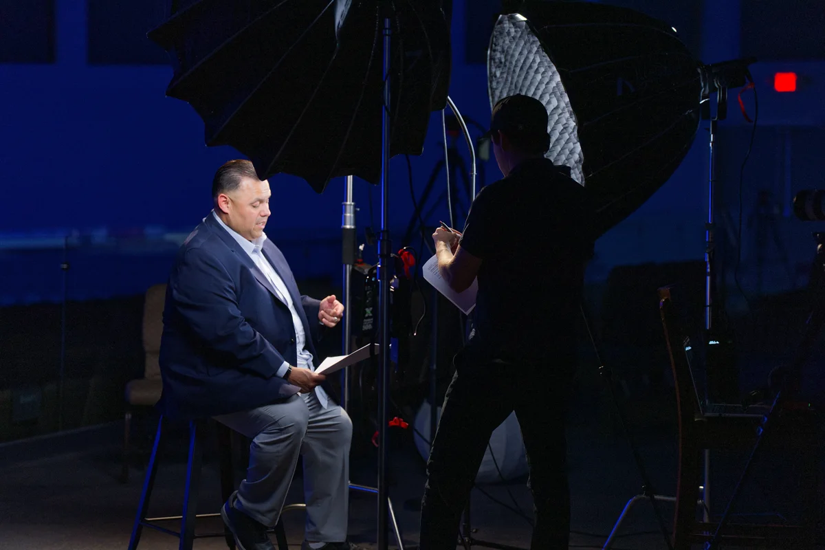 Dan reviewing a script with a client during a filming session